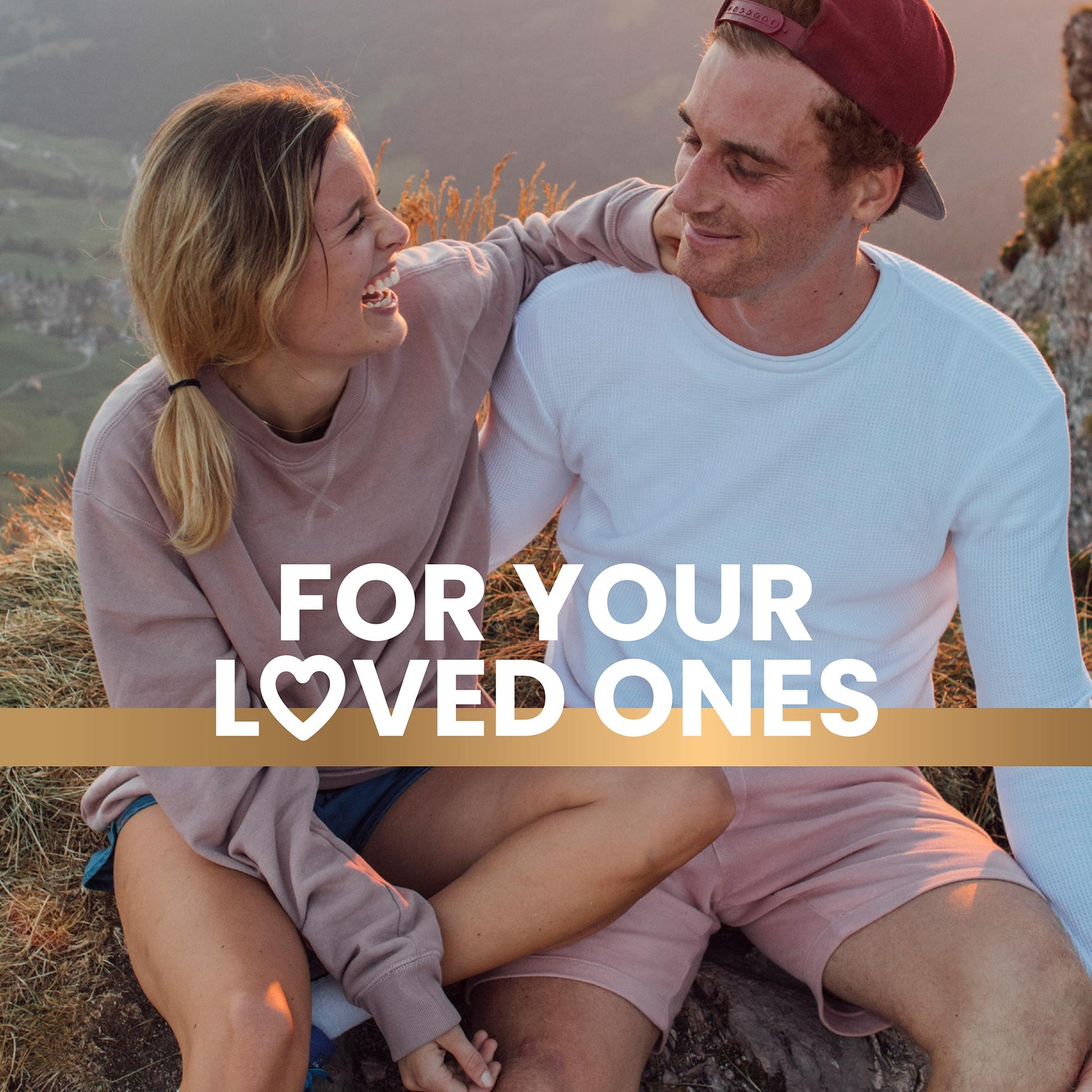 Young couple sitting on a rock on the hill happy enjoying life promoting a healthy lifestyle with Frisk supplements text overlay reads “For your loved ones” 